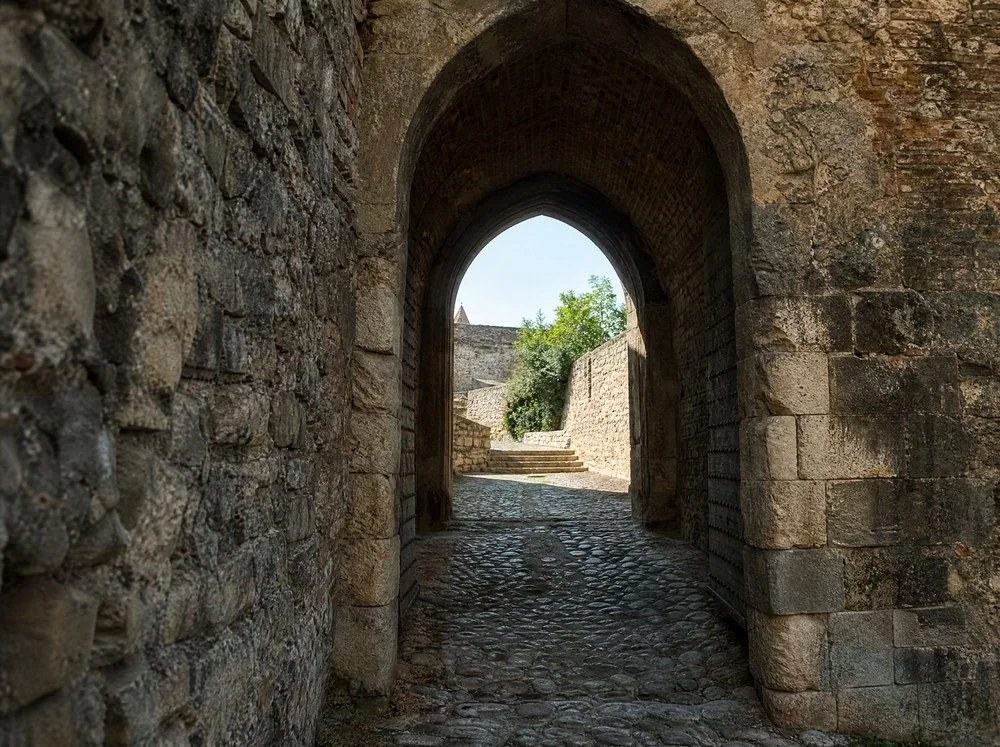 An arched stone gateway through a rampart