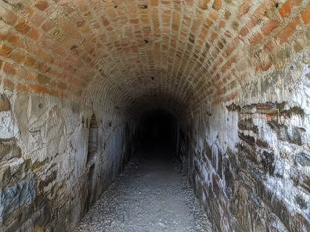 A lit brick gallery running underground